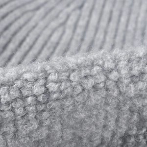 Close-up of grey ribbed knit and sherpa wool texture for a warm winter beanie hat