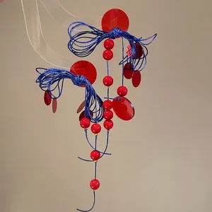 Resin geometric knot fringe earrings with red beads and blue rope in ethnic style