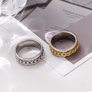 Macro shot of silver and gold chain rotating bottle opener rings on a decorative card