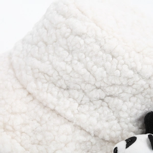 Detailed macro view of white sherpa fleece fabric and cute panda plush toy on bucket hat