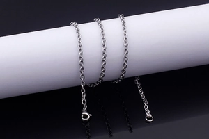 Close-up of silver Rolo chain texture and stainless steel lobster clasp detail
