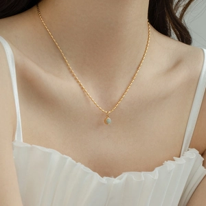 Elegant gold-plated aventurine bead necklace shown on a model neck for a minimalist look