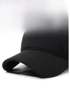 Detail of black winter baseball cap with silver metal shield and thick knit texture