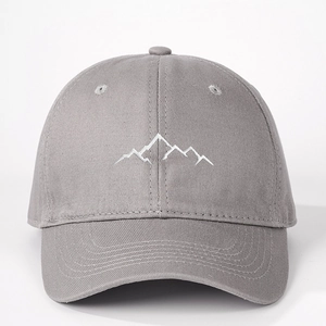 Close-up of white mountain peak embroidery on a dark grey cotton twill baseball cap