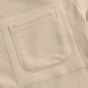 Detail of beige corduroy fabric texture and patch pocket stitching on men's sweatshirt