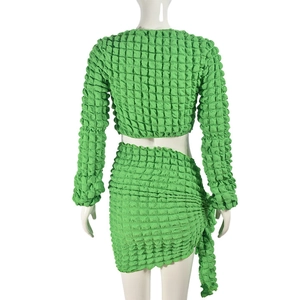 Detailed back view of green popcorn texture fabric on crop top and mini skirt set