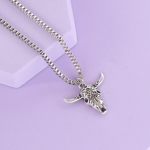Retro silver bull head pendant necklace with turquoise stone on geometric purple stand