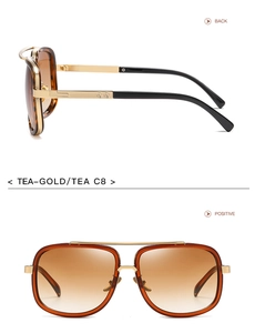 Detail view of gold metal aviator sunglasses with brown gradient lenses and side profile