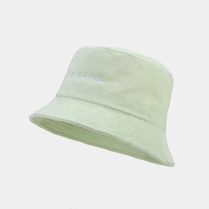 Close-up of mint green bucket hat featuring white mama embroidery and terry cloth texture