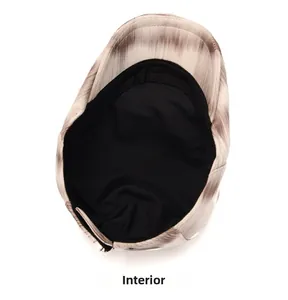 Detailed interior view of vintage gradient tie-dye flat cap with soft black fabric lining