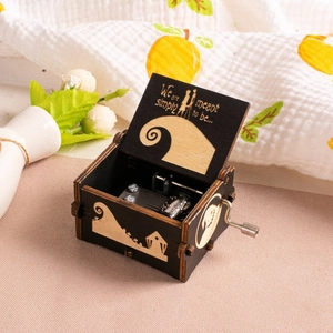 Close-up of wooden music box with Nightmare Before Christmas engraving and metal movement