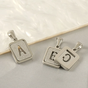 Detailed view of silver rectangular letter pendants with frosted sand texture A B C
