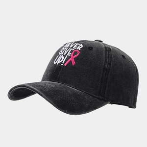 Close-up of pink ribbon and Never Give Up embroidery on grey washed cotton baseball cap