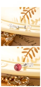 Macro detail of multifaceted crystal ball stud earrings with clear water drop pendants