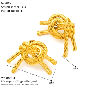 Detail view of gold woven knot earrings in stainless steel with exact size dimensions