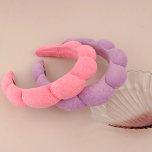 Detail of pink and purple padded sponge headbands with soft plush velvet texture