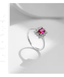 Macro shot of square cut red ruby ring with halo diamonds on S925 sterling silver