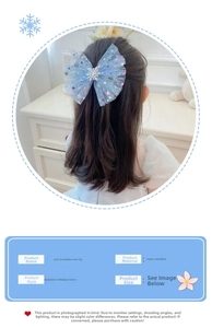 Close-up of blue mesh hair bow with snowflakes on girl model for princess look
