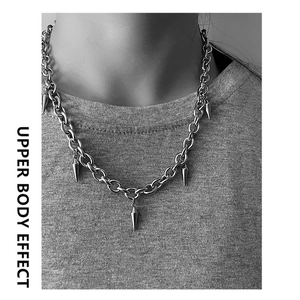 Upper body effect of a silver punk titanium steel chain necklace with cone tassel pendants