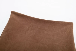 Close-up of coffee brown suede fabric texture and stitching detail on skirt waist