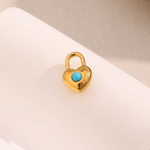 Detailed close-up of a 18K gold-plated heart pendant with an inlaid turquoise stone
