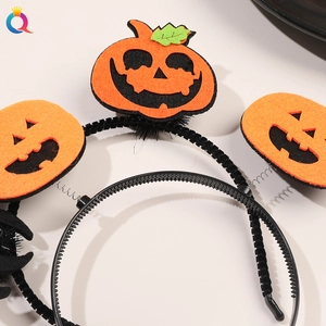 Detail view of Halloween headband with orange felt pumpkins on springs and black spider