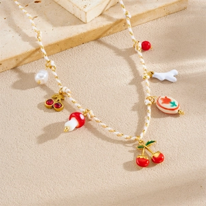 Boho necklace with cherry, mushroom, and pearl pendants on gold-white woven chain