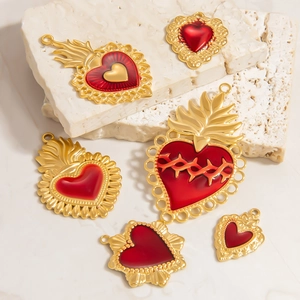 Detailed macro shot of vintage Gothic 18k gold heart pendants on stone background