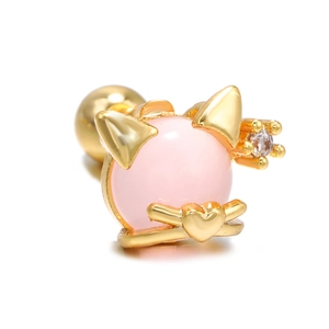 Macro detail of cat-shaped gold ear stud with pink gemstone and heart accents