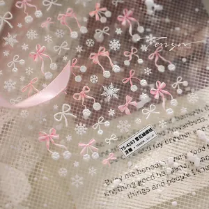 Macro shot of 3D embossed snowflake and pink bow nail stickers, model TS-4263 detail