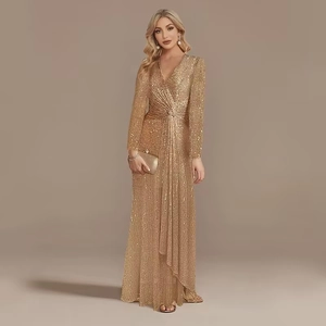 Detail of gold sequin evening gown with deep V-neck, long sleeves and mermaid tail hem