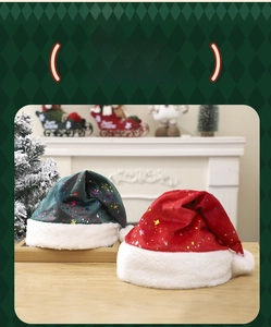 Detail of red and green plush Christmas hats with colorful star sequins on wood table