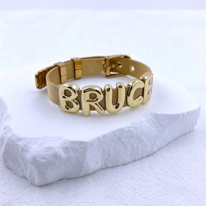 Gold mesh watch strap bracelet with personalized BRUCE 3D letter charms on white stone