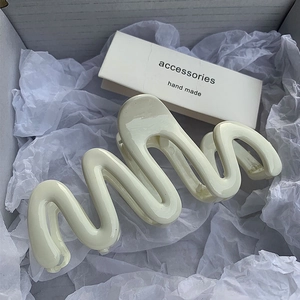 Creamy white wavy hair claw clip with glossy finish for elegant summer hair styling
