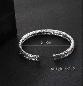 Detailed view of vintage silver open bangle with engraved texture and 5.8cm size mark