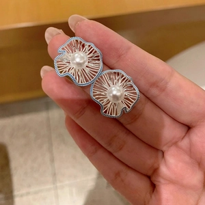 Silver flower stud earrings with central white pearl and blue enamel accents