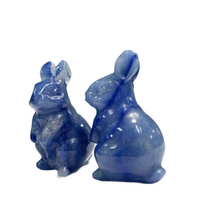 Polished blue natural crystal rabbit figurines with white veins on a white background