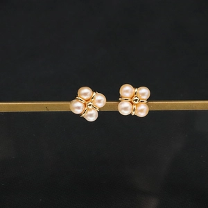 Elegant freshwater pearl cluster earrings with gold-plated finish on a display bar