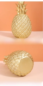 Detail of golden resin pineapple ornament featuring textured scales and flat stable base