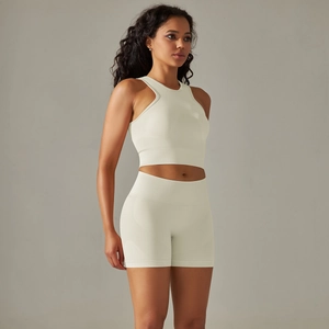 Detail of seamless knitted cream yoga set showing halter top and high waist shorts fabric