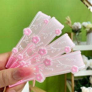 Creative pink acrylic keychain with floating flowers and Lucky text for bags