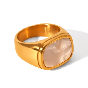 Detail view of a wide gold stainless steel open ring with a rectangular white shell inlay