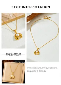 Macro detail of gold-plated horseshoe pendant with pearl inlay on a delicate chain