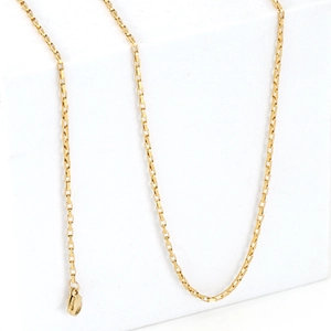 Minimalist gold stainless steel box chain necklace with lobster clasp on white cube