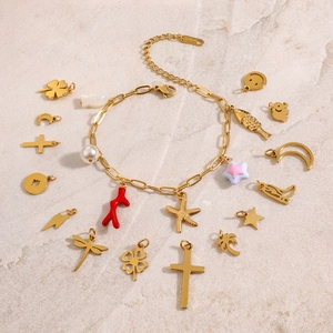 Gold stainless steel charm bracelet featuring starfish, moon, and clover pendant charms