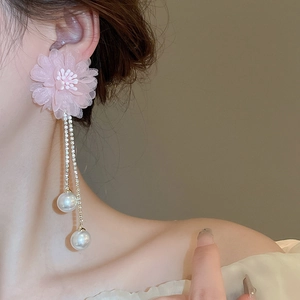 Elegant pink lace flower earrings with long pearl tassels and crystal accents on model