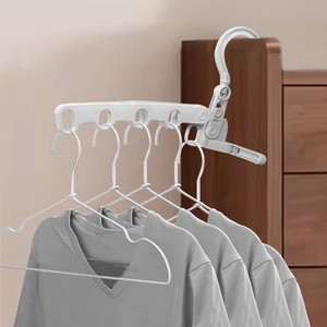 Portable 5-hole folding clothes hanger in white plastic showing 4 grey t-shirts hanging