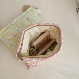 Detailed top view of floral cotton makeup pouches in green and pink with zipper closure