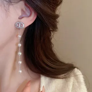Silver drop earrings featuring circular zirconia studs and long tassel pearls for women