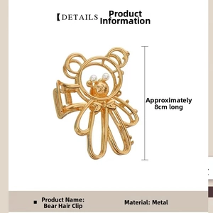 Detail view of golden metal bear hair claw clip with 8cm length size dimensions